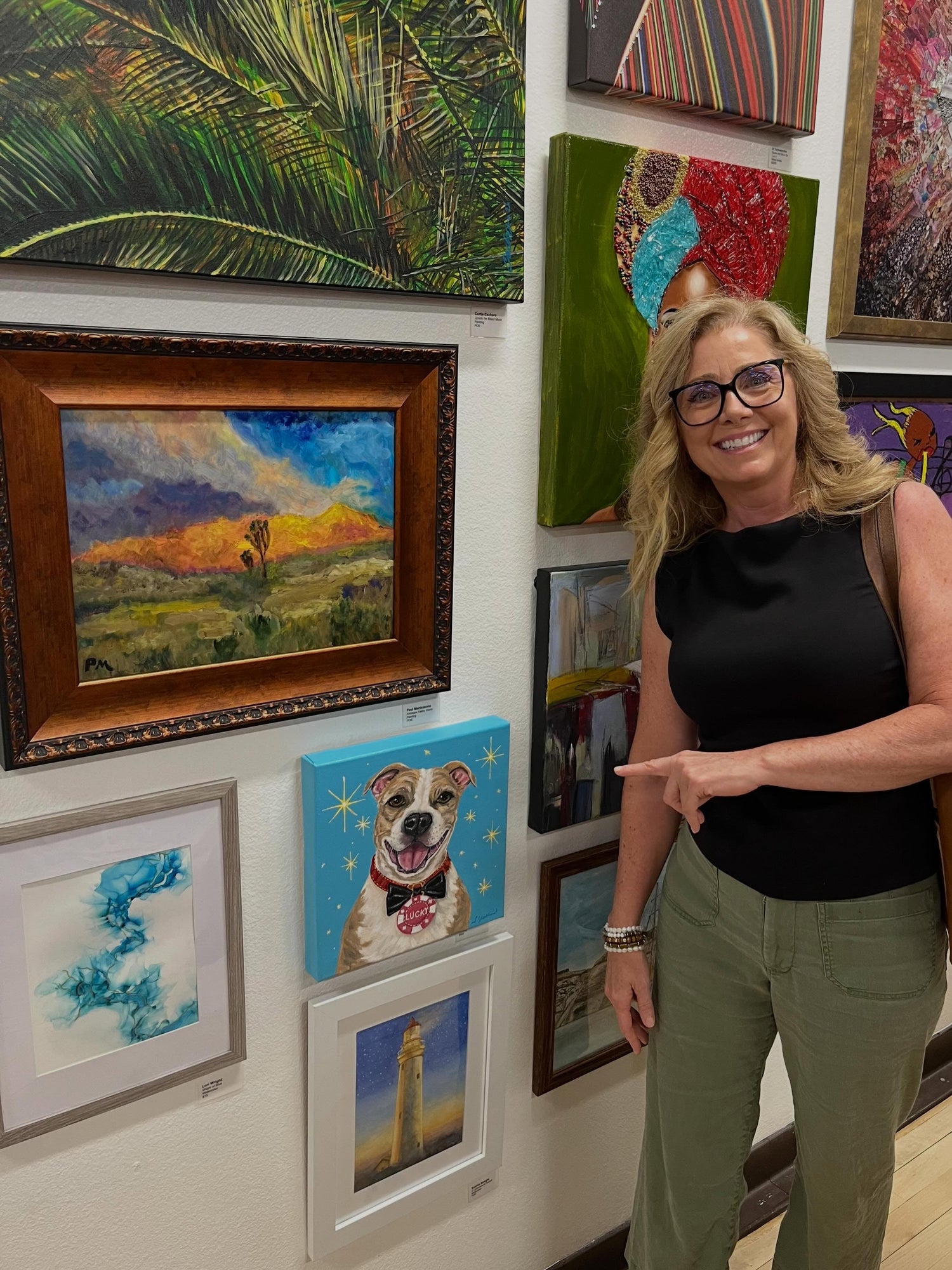 hannon Yelland standing beside her Vegas dog painting at the Celebrating Life 2026 Exhibition